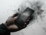 Disintegrating smartphone symbolizing impact of Musk's Tesla tweet on JPMorgan lawsuit